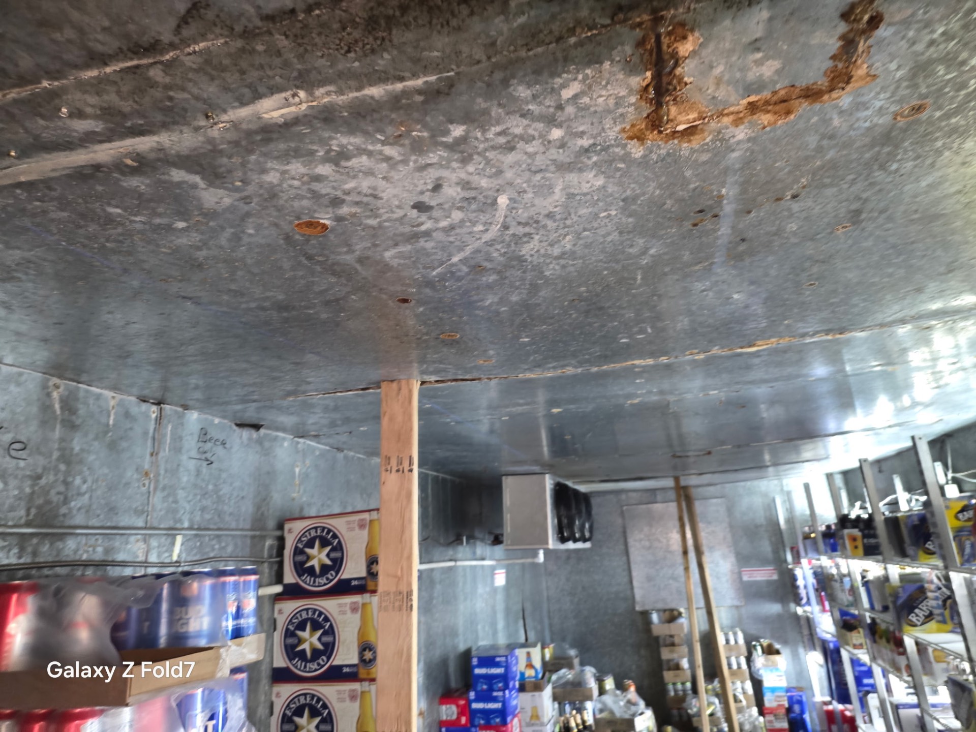 Interior of a commercial walk-in beer cooler with evaporator unit serviced by RioTech Services